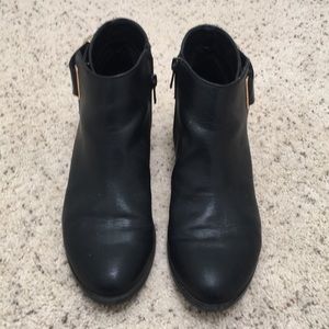 Black flat bootie with gold buckle